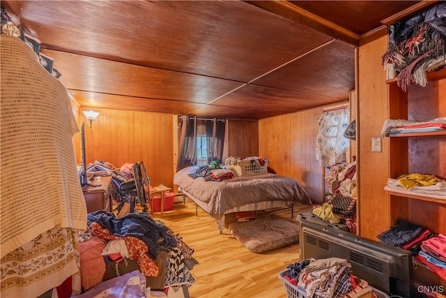 bedroom with hardwood / wood-style floors, wooden ceiling, and wooden walls