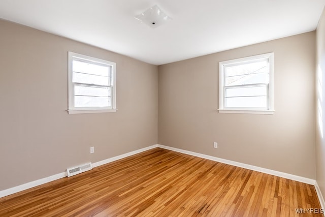 spare room with light hardwood / wood-style floors