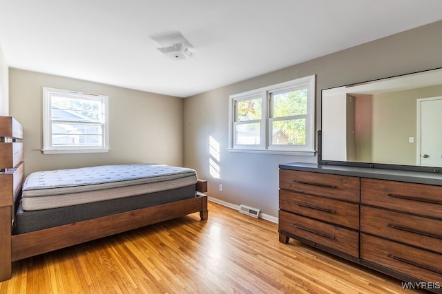 bedroom featuring multiple windows and light wood-type flooring