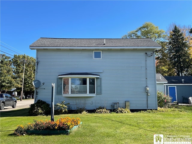 view of side of property with a lawn