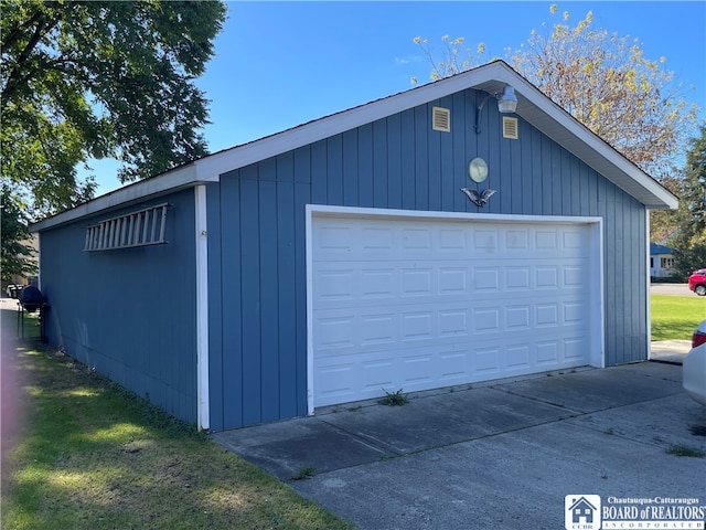 garage featuring wooden walls