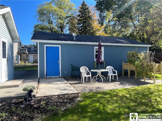 view of outbuilding with a lawn