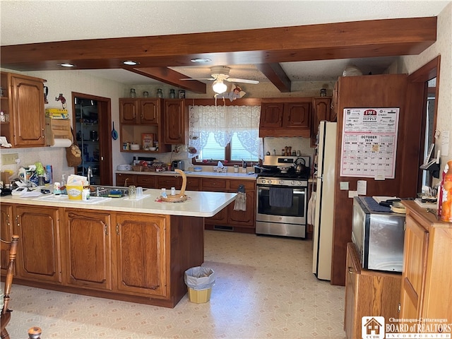 kitchen featuring kitchen peninsula, beam ceiling, ceiling fan, a textured ceiling, and stainless steel appliances