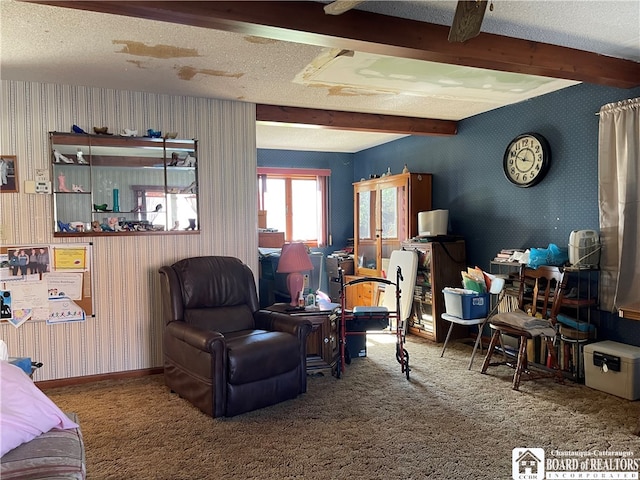 carpeted living room with beam ceiling and a textured ceiling