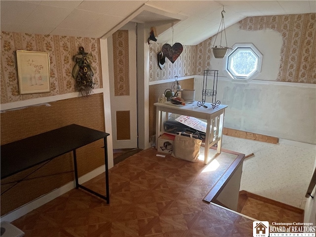 interior space featuring lofted ceiling and parquet floors