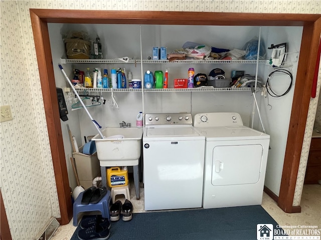 clothes washing area with sink and separate washer and dryer