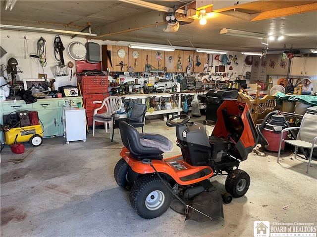 garage with a garage door opener and a workshop area