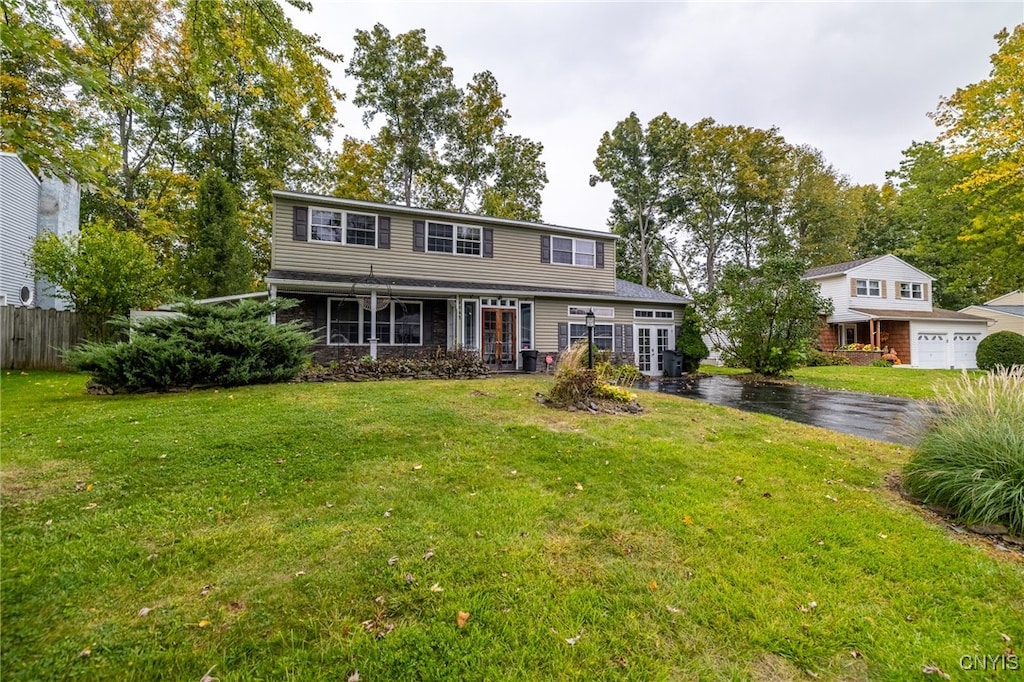 view of front of house featuring a front yard and a garage