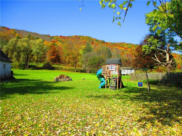 view of play area featuring a mountain view and a lawn