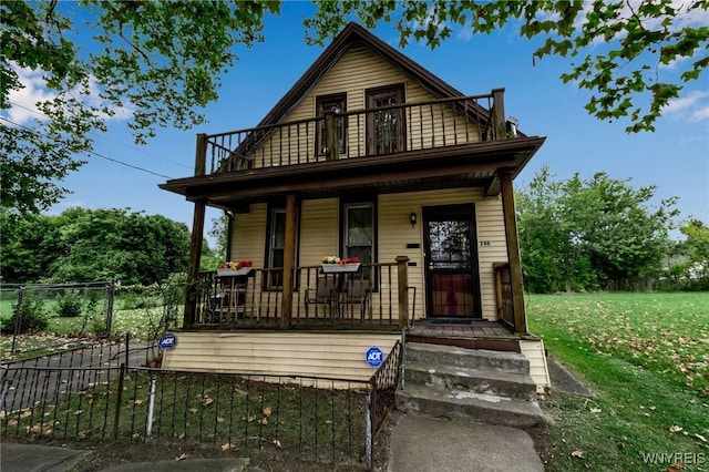 bungalow featuring a porch and a front lawn