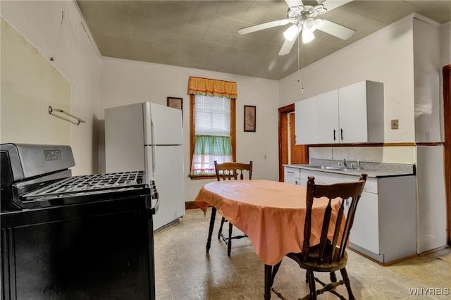 dining room featuring ceiling fan, ornamental molding, and sink