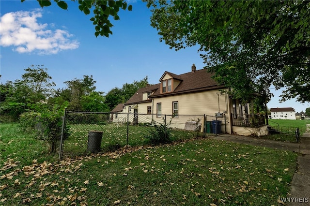 view of side of home with a lawn