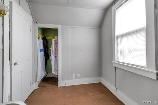 unfurnished bedroom with vaulted ceiling