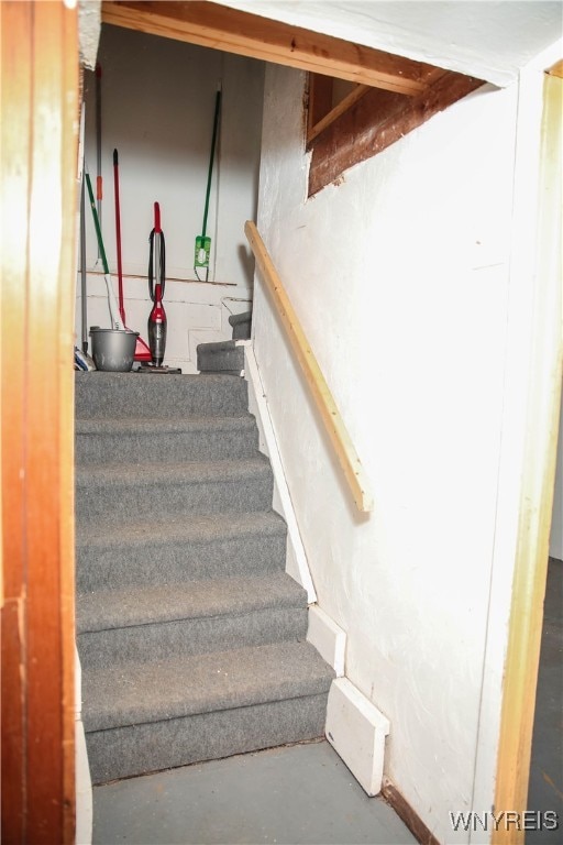 stairway with concrete flooring