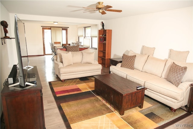 living room featuring hardwood / wood-style flooring and ceiling fan