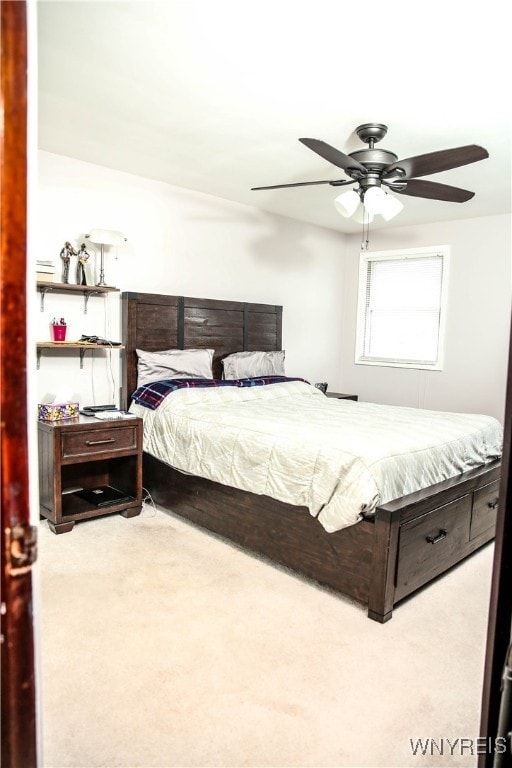 bedroom with light carpet and ceiling fan