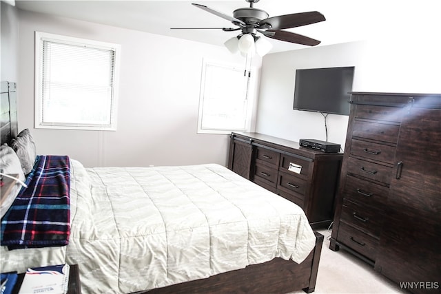 bedroom with light colored carpet and ceiling fan