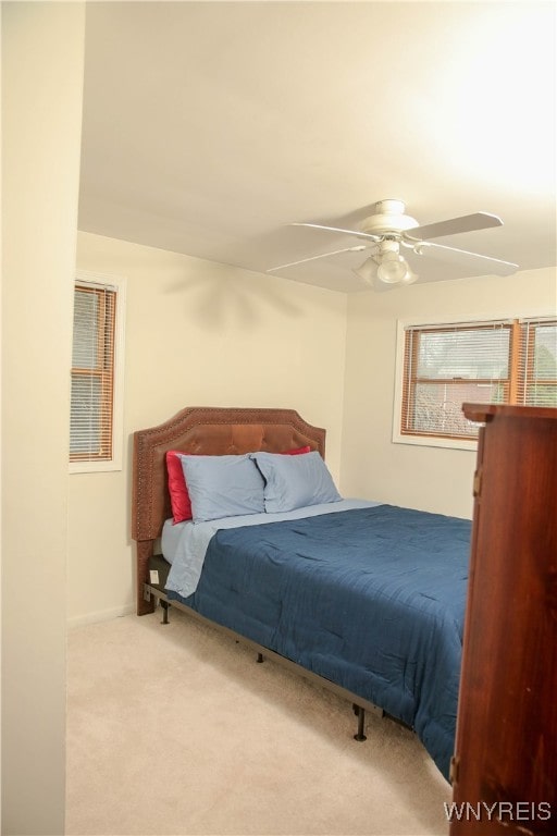 bedroom with ceiling fan and light colored carpet