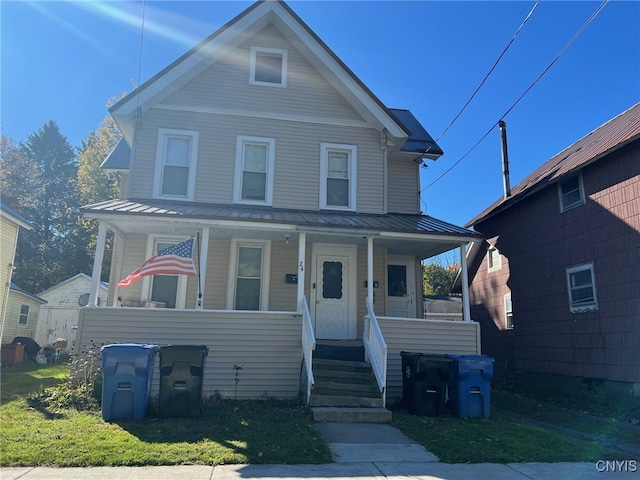 view of front facade featuring a front lawn and covered porch