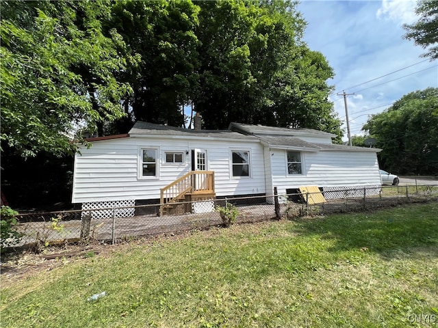 rear view of house with a lawn