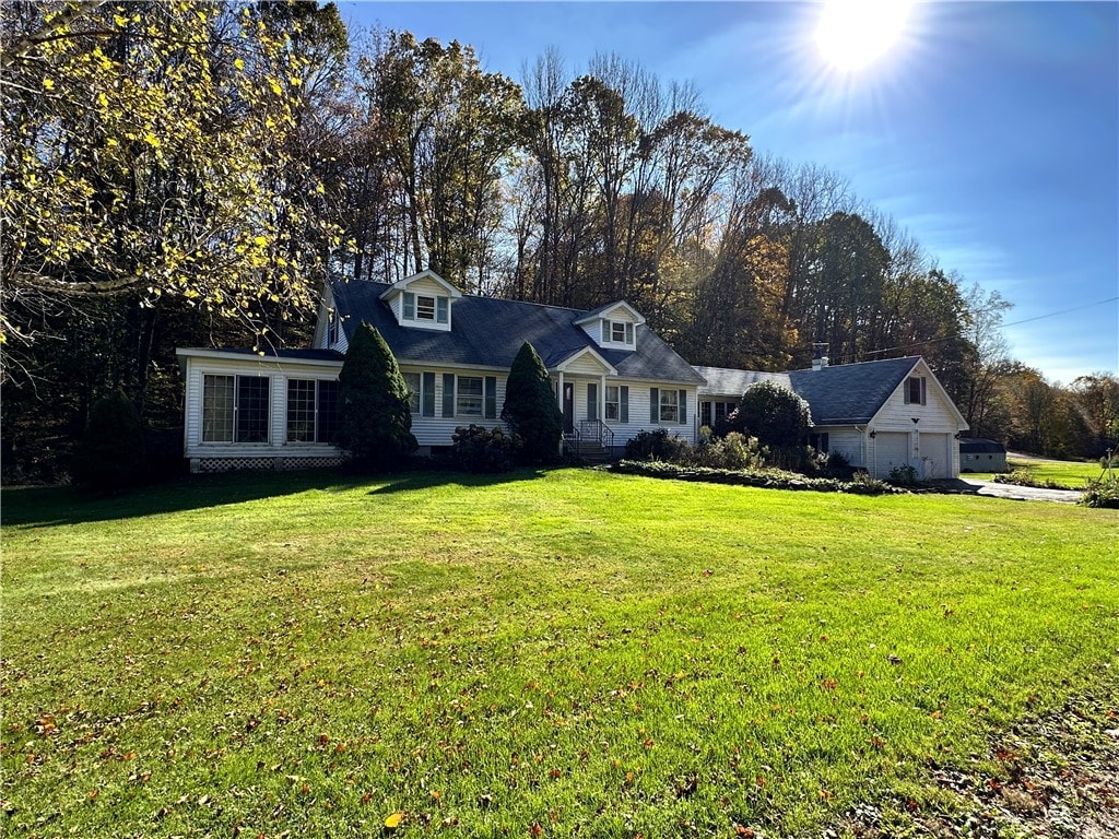 cape cod home with a front yard