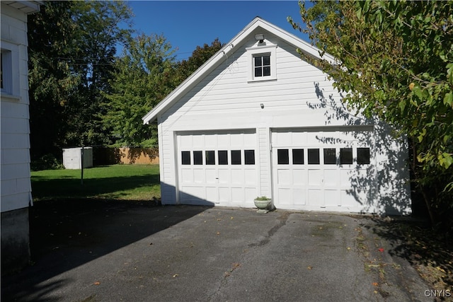 garage featuring a yard