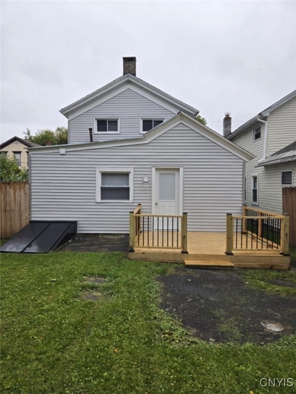 back of house featuring a deck and a yard