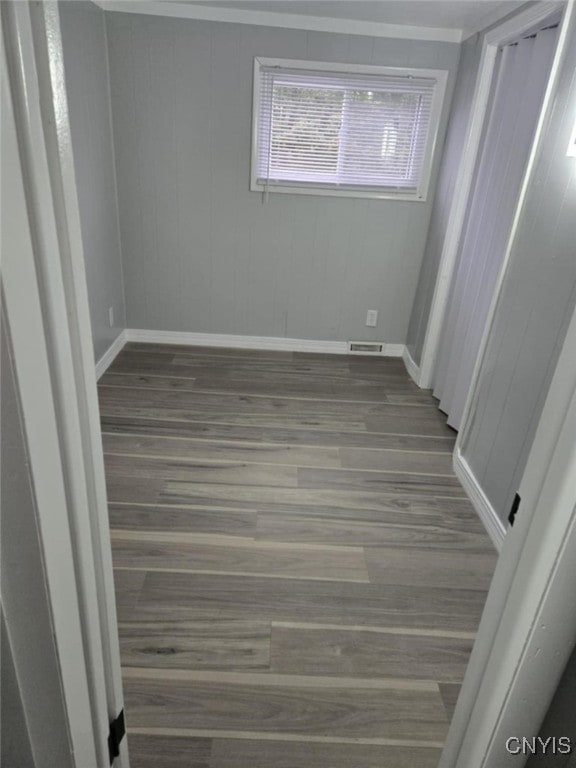 empty room with dark hardwood / wood-style flooring