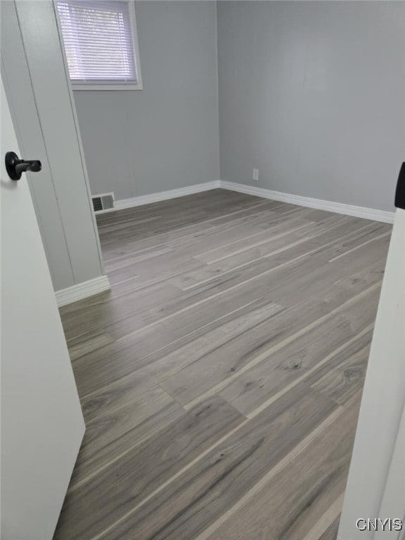 spare room featuring light wood-type flooring