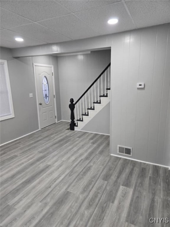 entrance foyer featuring a drop ceiling and hardwood / wood-style flooring