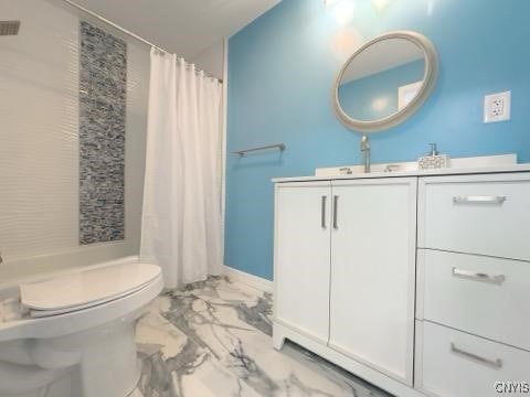 bathroom featuring vanity, curtained shower, and toilet