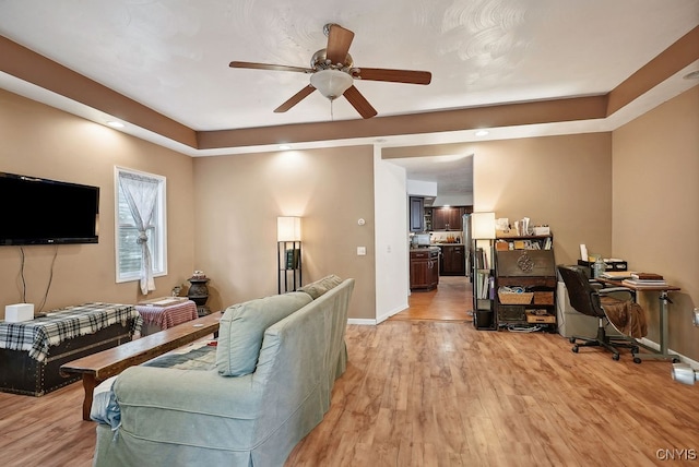 living room featuring light hardwood / wood-style floors and ceiling fan