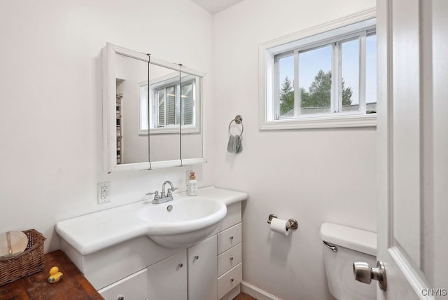 bathroom featuring toilet and vanity