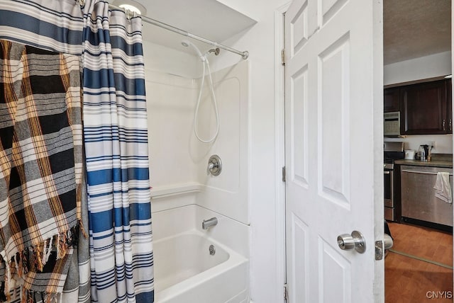 bathroom with shower / tub combo with curtain and wood-type flooring