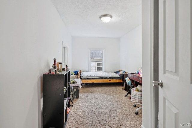 carpeted bedroom featuring a textured ceiling