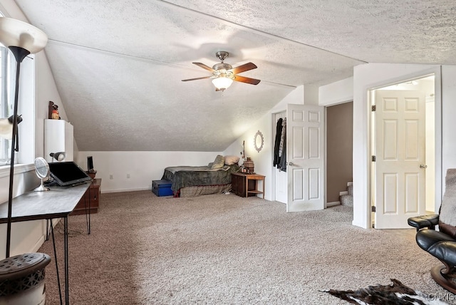 carpeted office with lofted ceiling, a textured ceiling, and ceiling fan