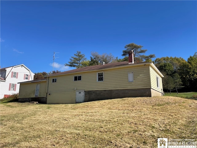 back of property featuring a yard