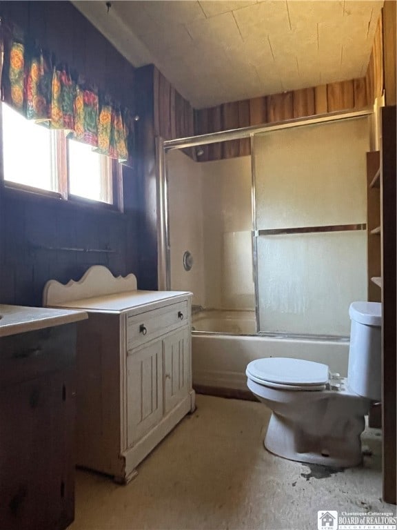 full bathroom featuring toilet, enclosed tub / shower combo, and vanity