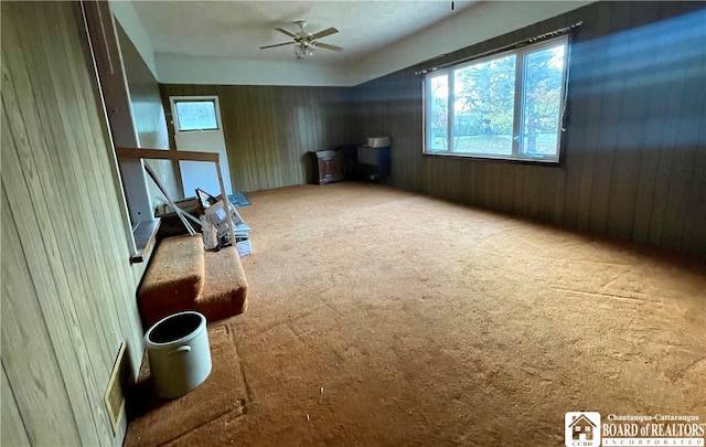 carpeted spare room with ceiling fan