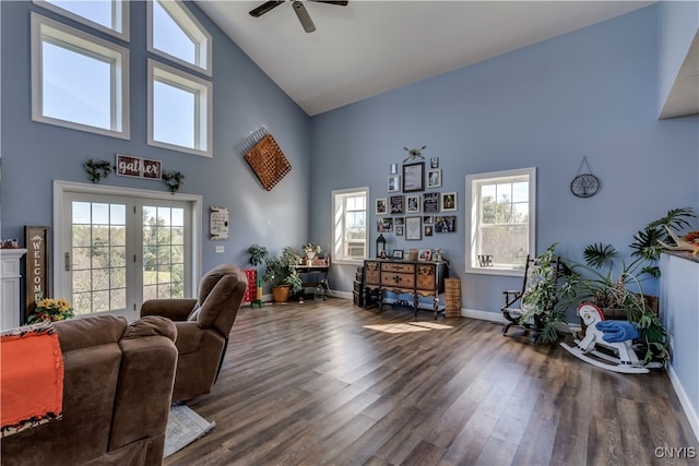 living room featuring dark wood-type flooring, ceiling fan, and high vaulted ceiling