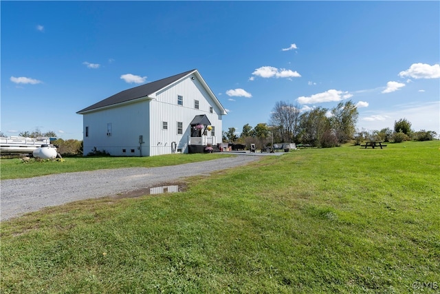 view of property exterior with a lawn