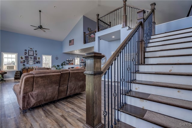 living room with hardwood / wood-style flooring, high vaulted ceiling, and ceiling fan