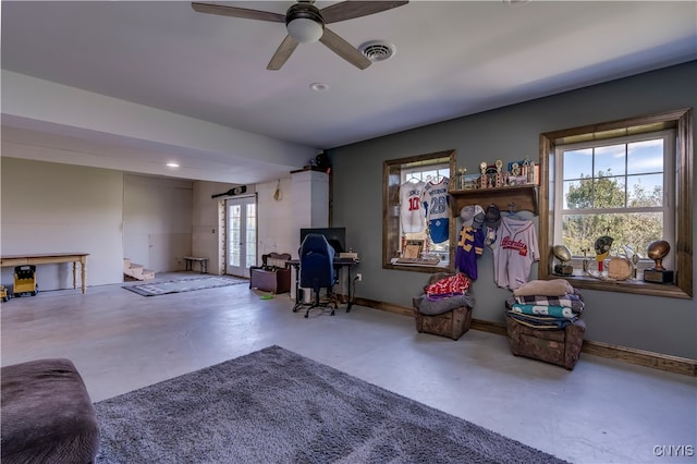 interior space with ceiling fan, concrete flooring, and plenty of natural light