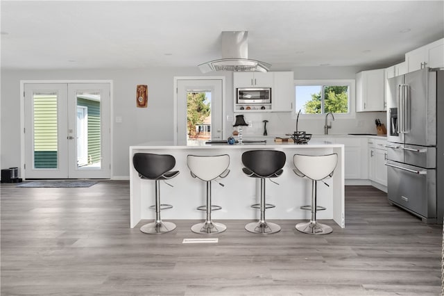 kitchen with white cabinetry, appliances with stainless steel finishes, and a wealth of natural light