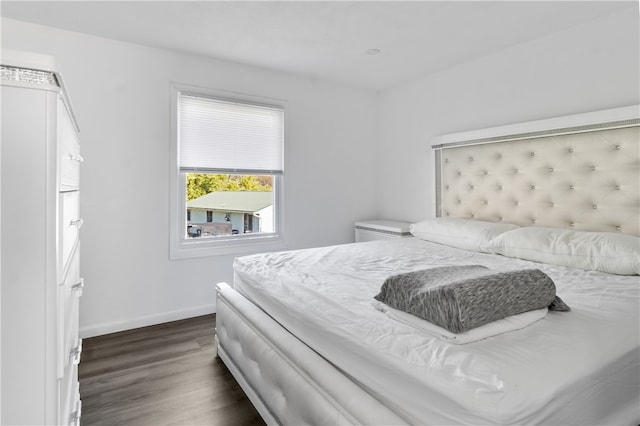 bedroom with dark hardwood / wood-style flooring