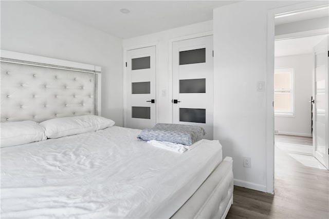 bedroom with dark hardwood / wood-style flooring