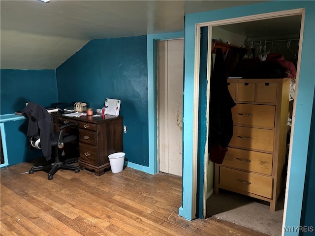 home office featuring lofted ceiling and light wood-type flooring