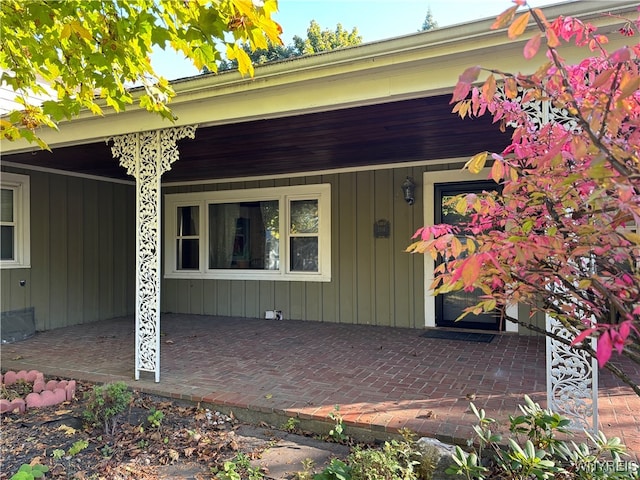 view of exterior entry featuring a patio area