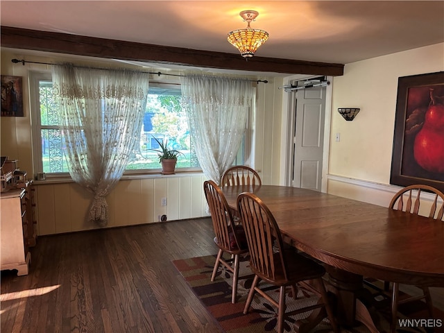 dining area featuring dark wood-type flooring and a barn door