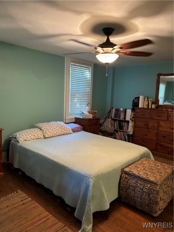 bedroom with ceiling fan and dark hardwood / wood-style flooring